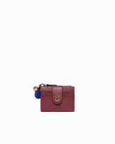 Portefeuille multifonction en cuir avec pompon - | Pinko