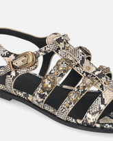 Sandalias planas de piel con estampado de pitón y tachuelas - | Pinko