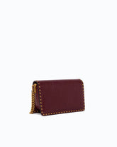 Small Love One Slouchy crossbody bag in leather with studs - Bordeaux | Pinko